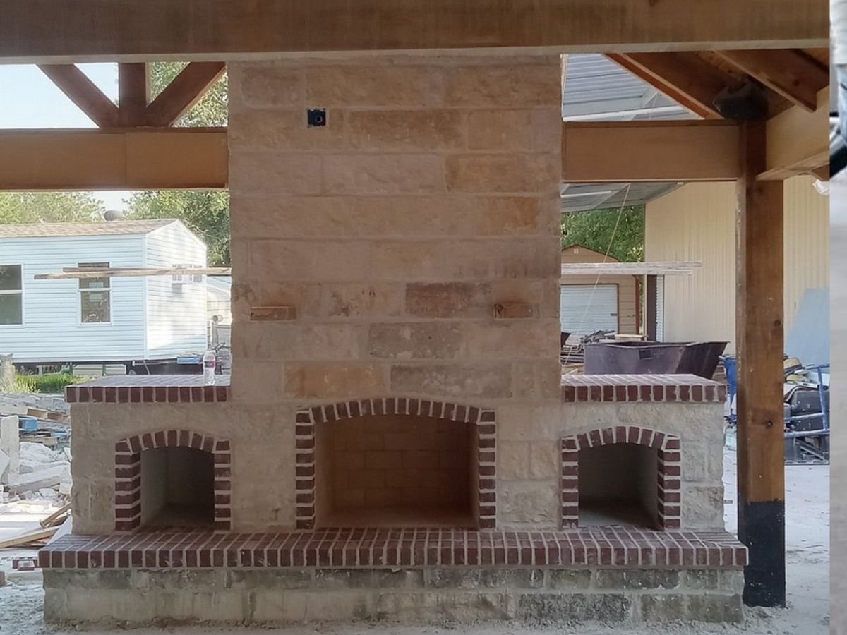 Stone and brick fireplace under pavilion