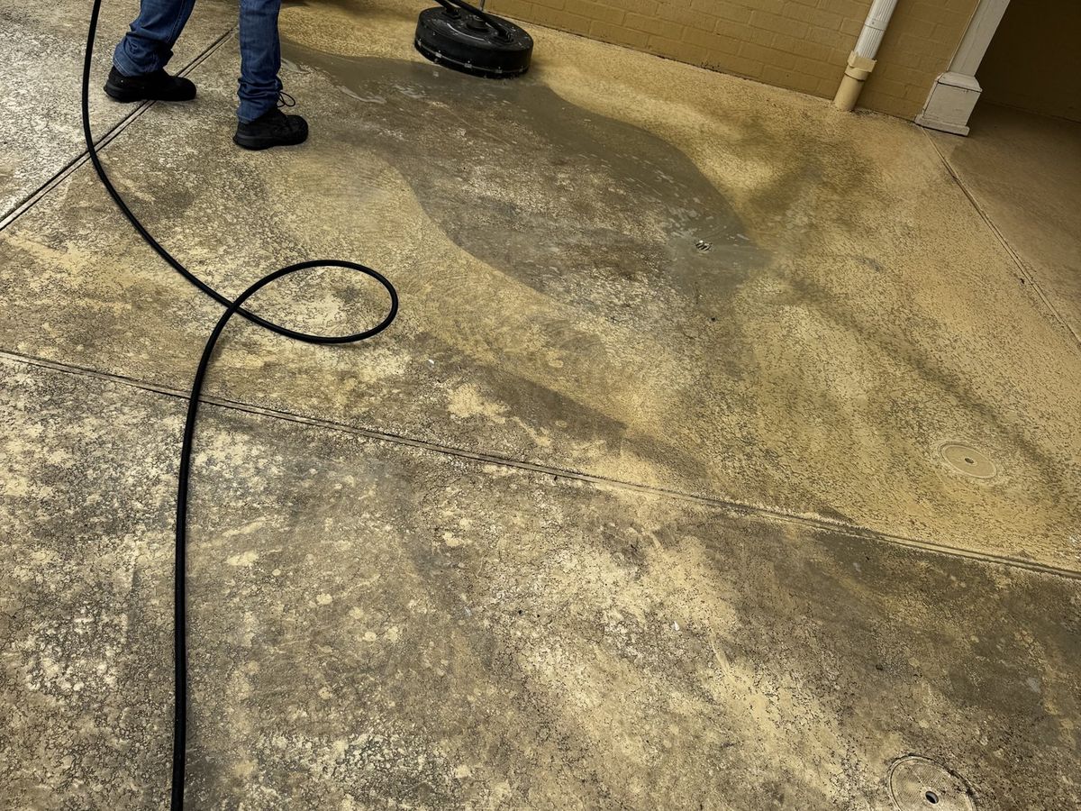 Surface cleaner lifting years of buildup off the concrete
